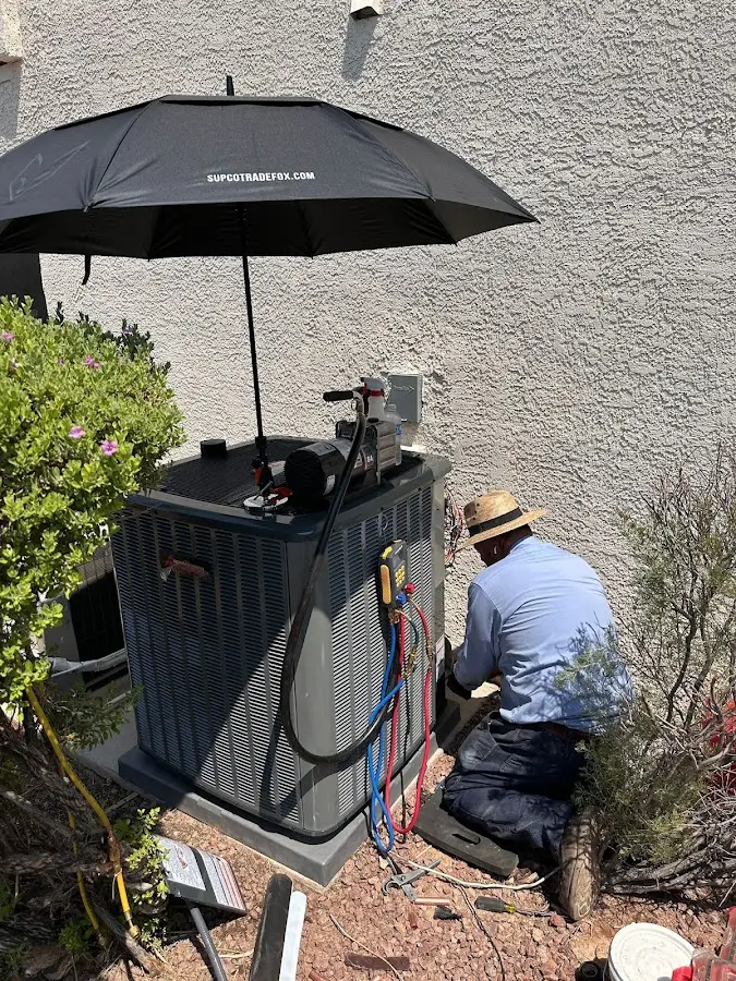 HVAC technician performing outdoor AC maintenance in Lower Macungie